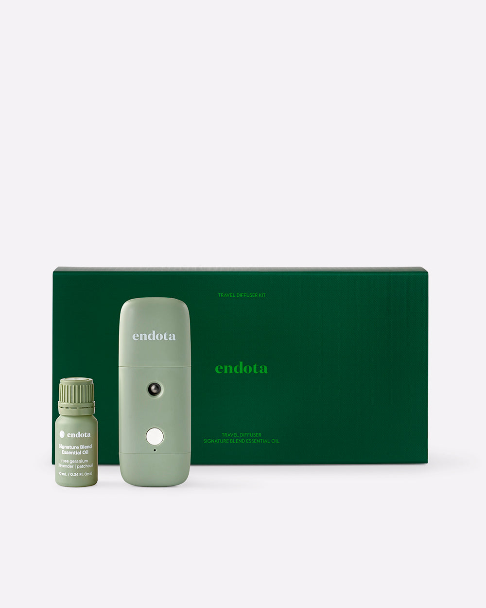 endota travel diffuser kit featuring a sage green portable diffuser, a small essential oil bottle, and a dark green gift box on a light grey background.