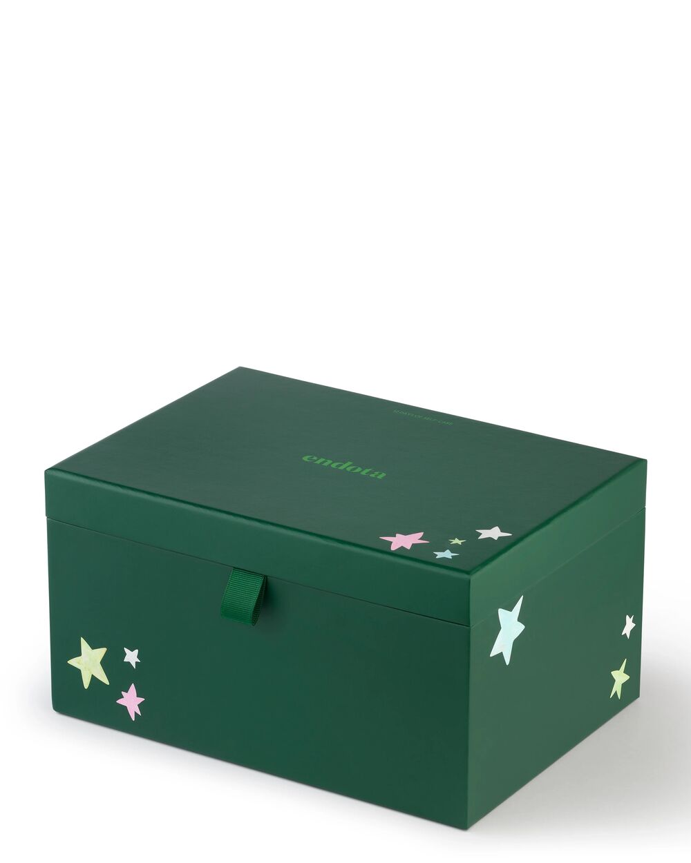 A dark green rectangular beauty advent calendar box with a hinged lid, featuring small pastel star illustrations in pink, yellow, and light blue, and the brand name 'endota' printed in green on the lid.