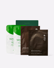 Four skincare sheet mask pouches from endota arranged against a light grey background, including two white and green stand-up pouches in the back and two dark brown packets in the front.