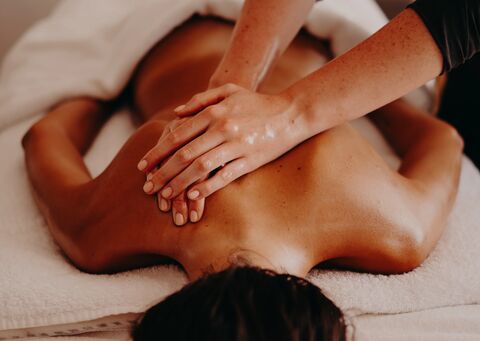 Person receiving a massage on a towel-covered surface