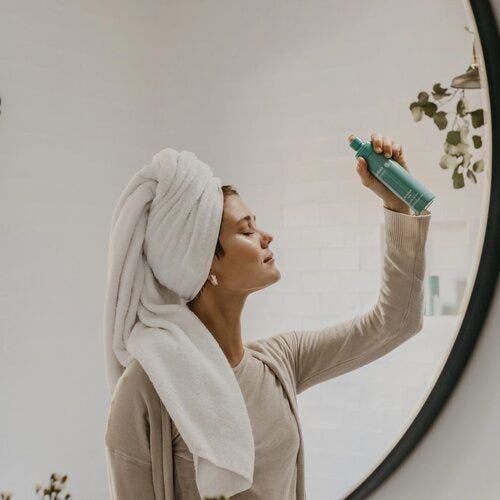 Woman hydrating her skin with hydrating facial mist during the cooler months
